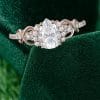 Elegant Pear Moissanite Ring with Infinity Twist Pavé Design (7)