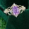 Vintage-Inspired Emerald Cut Purple Sapphire Halo Ring with Intricate Filigree and Milgrain Detailing (1)
